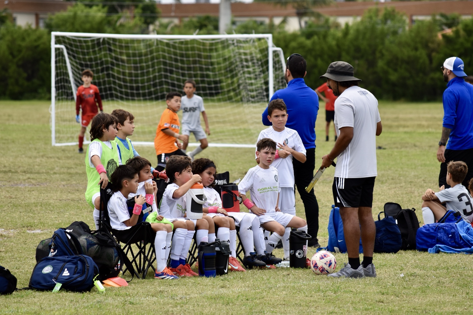 Coach Ricky speaking with young players during a soccer camp